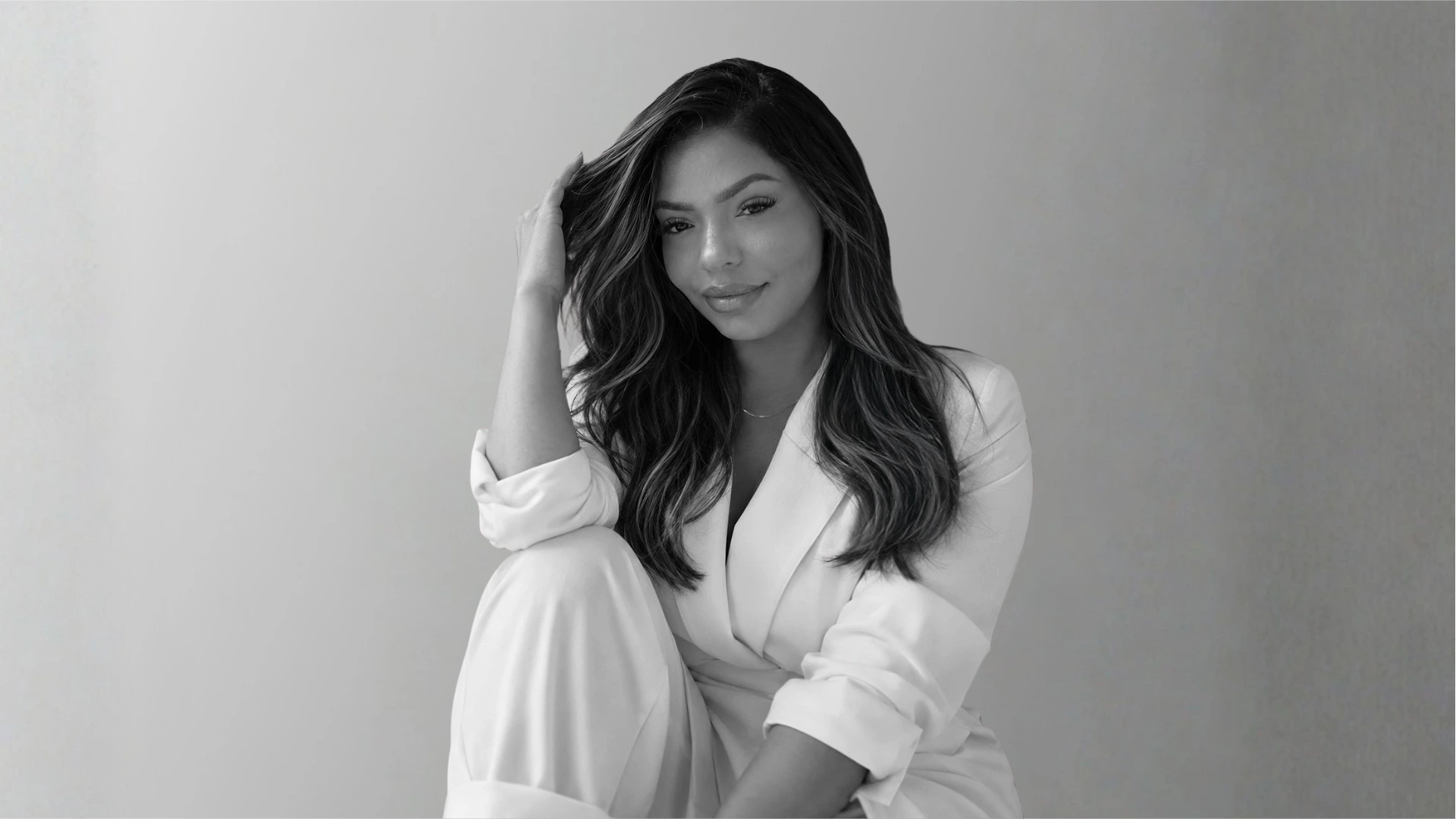 Arelis Santos in an elegant white suit